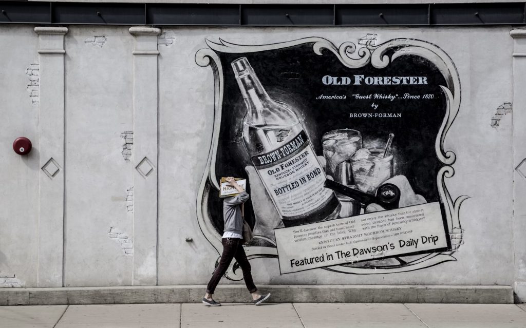 Vintage wall advertisement of Old Forester whiskey. Image via Unsplash