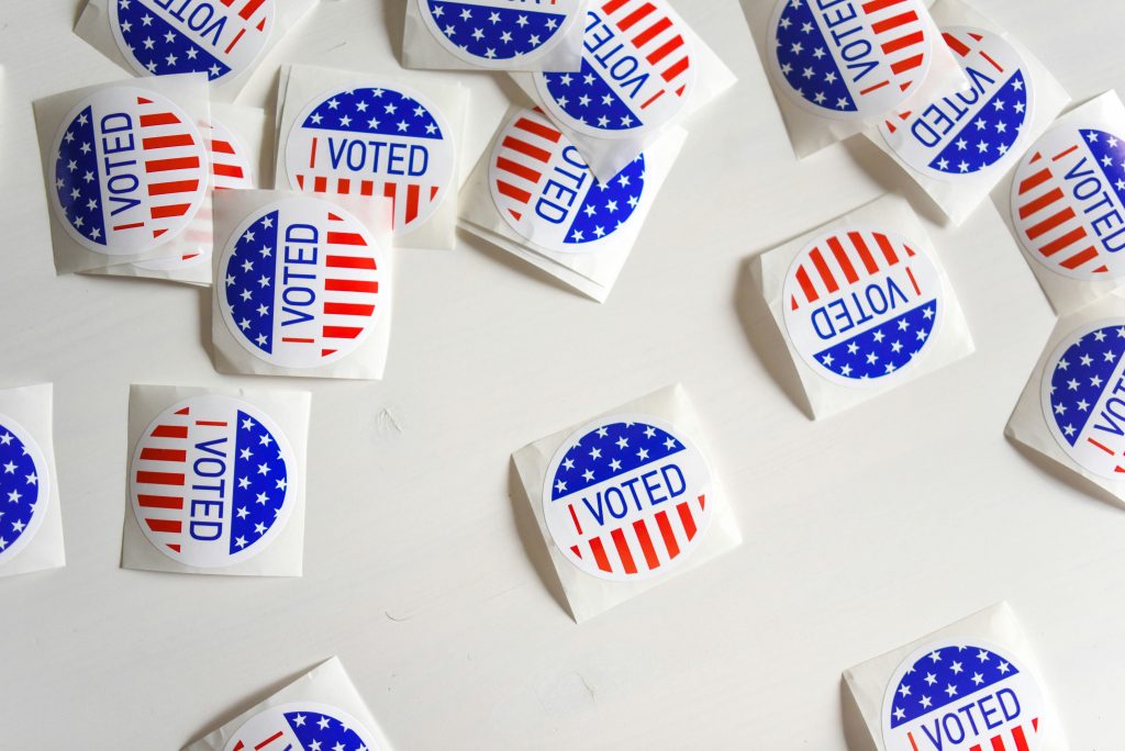 Political I voted stickers on a table. Via Unsplash