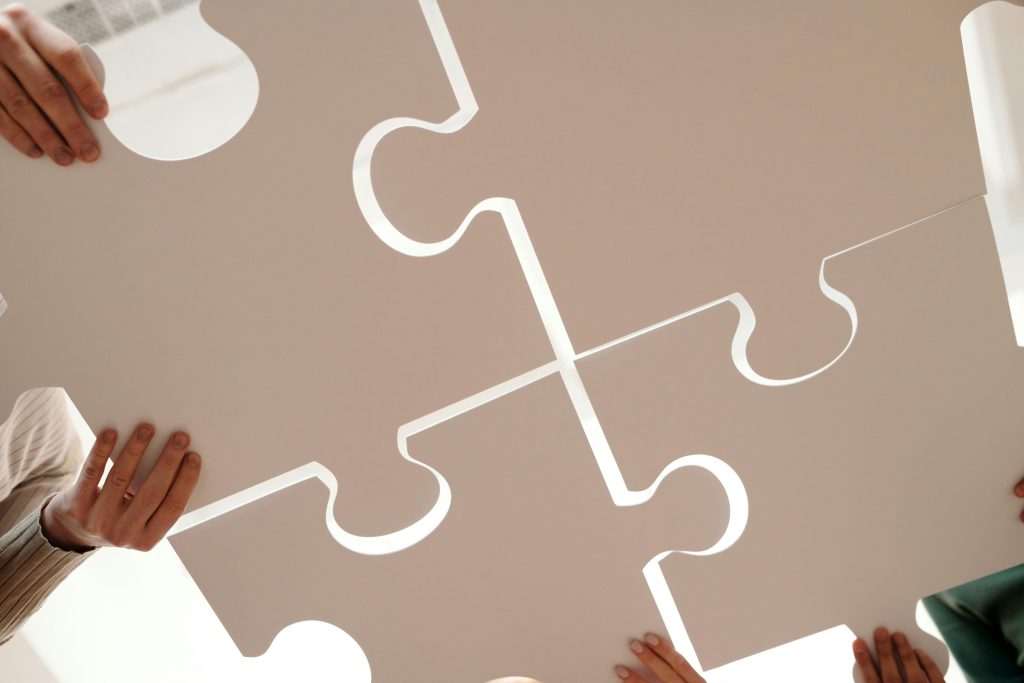 Marketing and advertising depicted by large puzzle pieces being put together