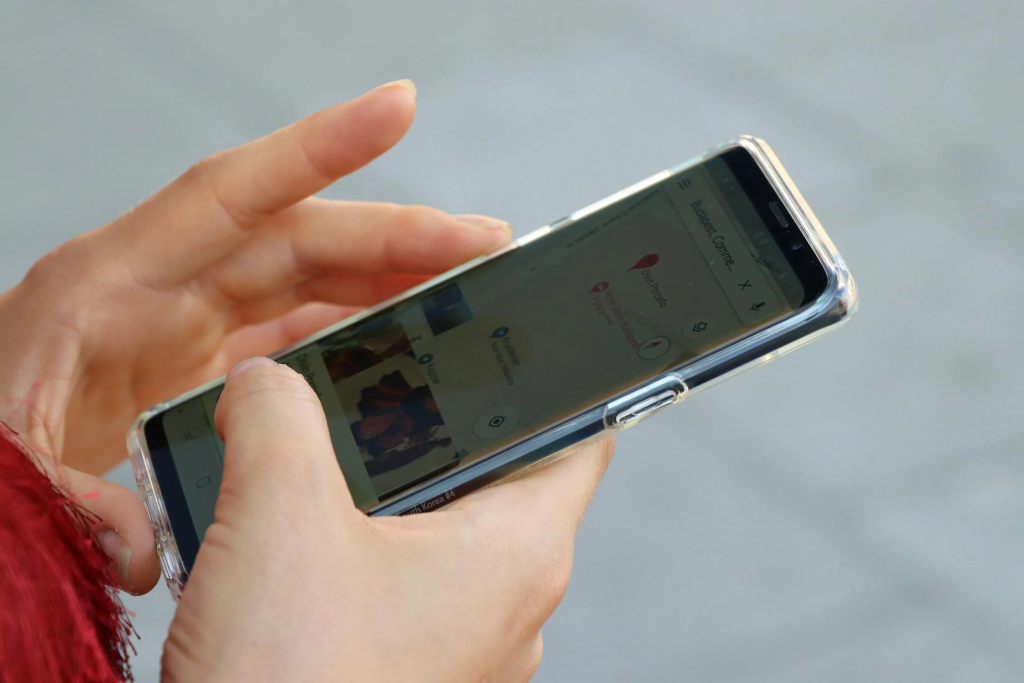 Close-up of a person's hand looking at their smartphone